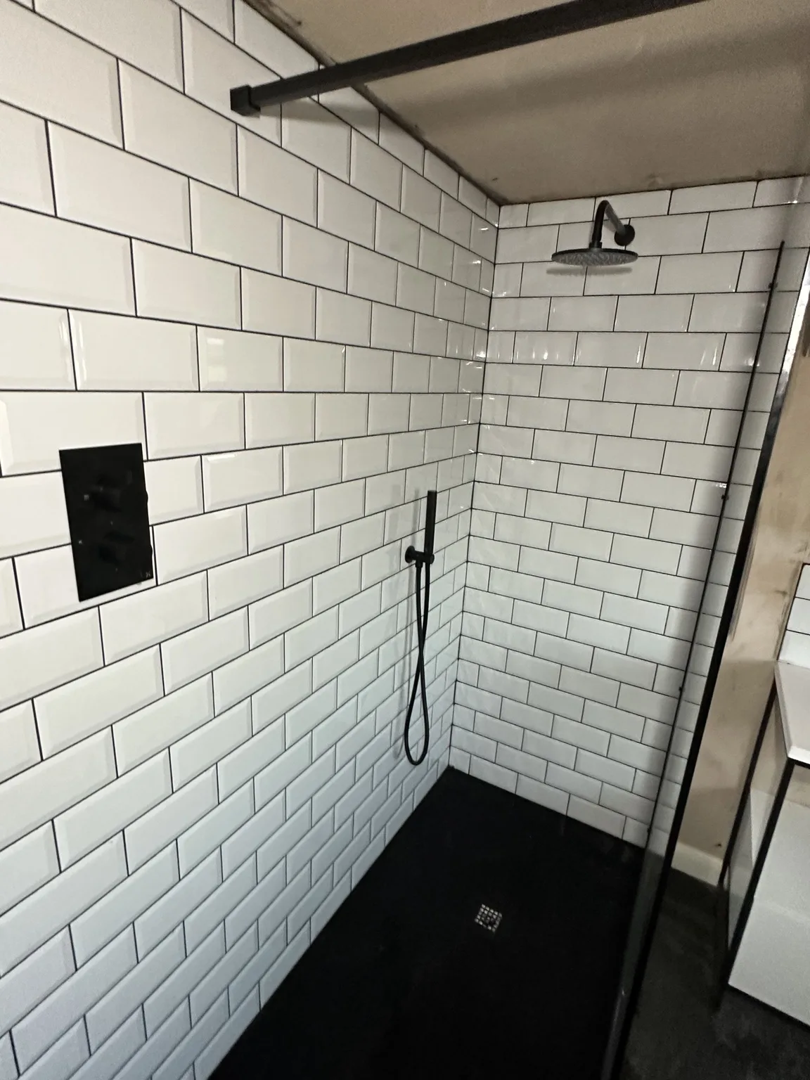 Loft-conversion walk-in shower with metro tiles and concealed fittings